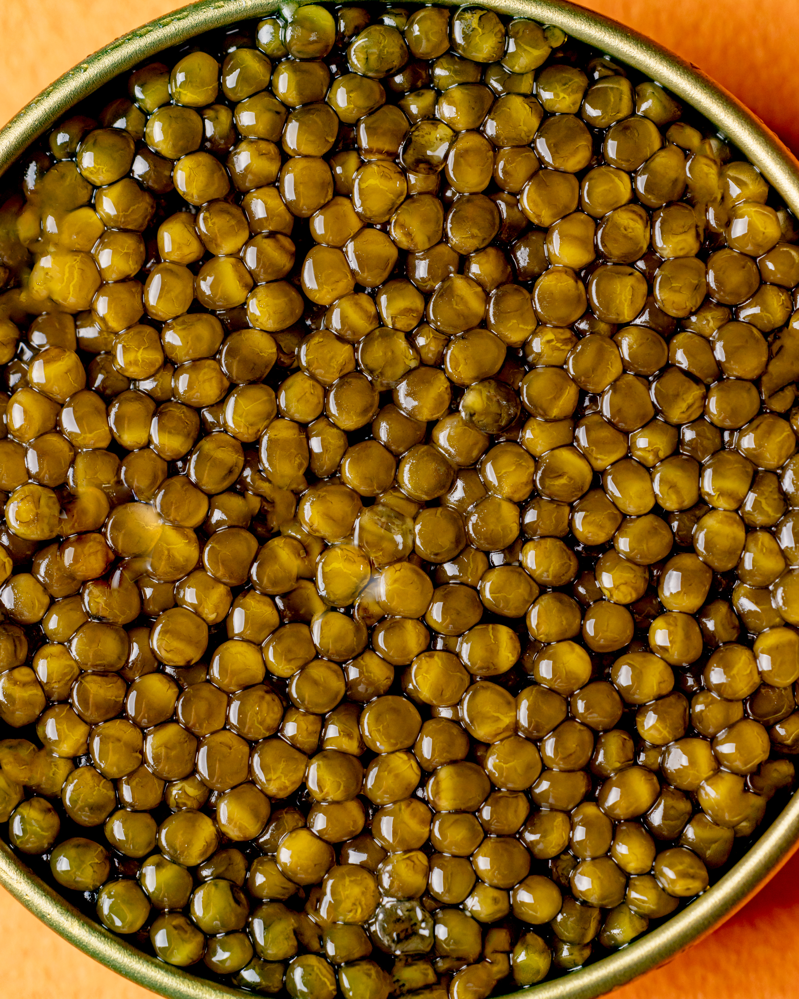 Imperial caviar pearls in a studio-lit tin with a golden rim